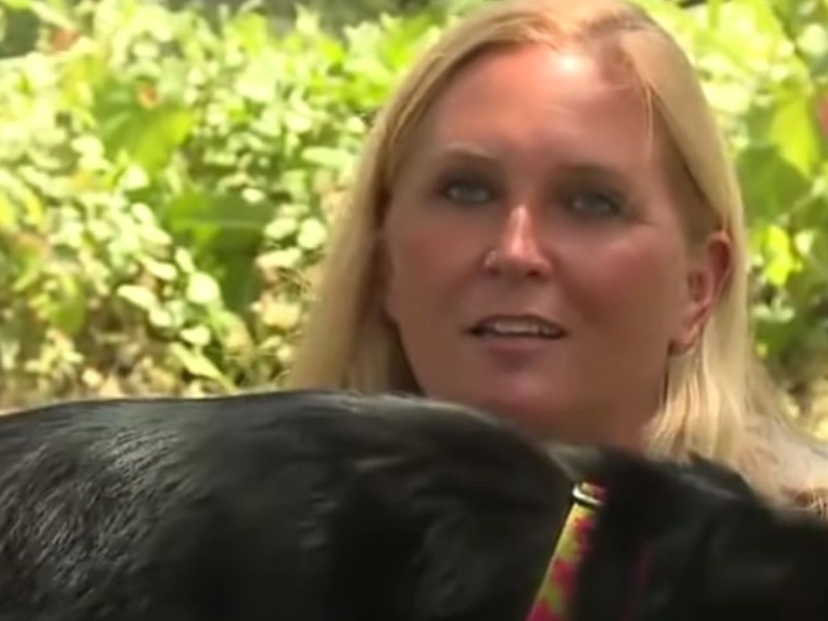 woman and black dog 