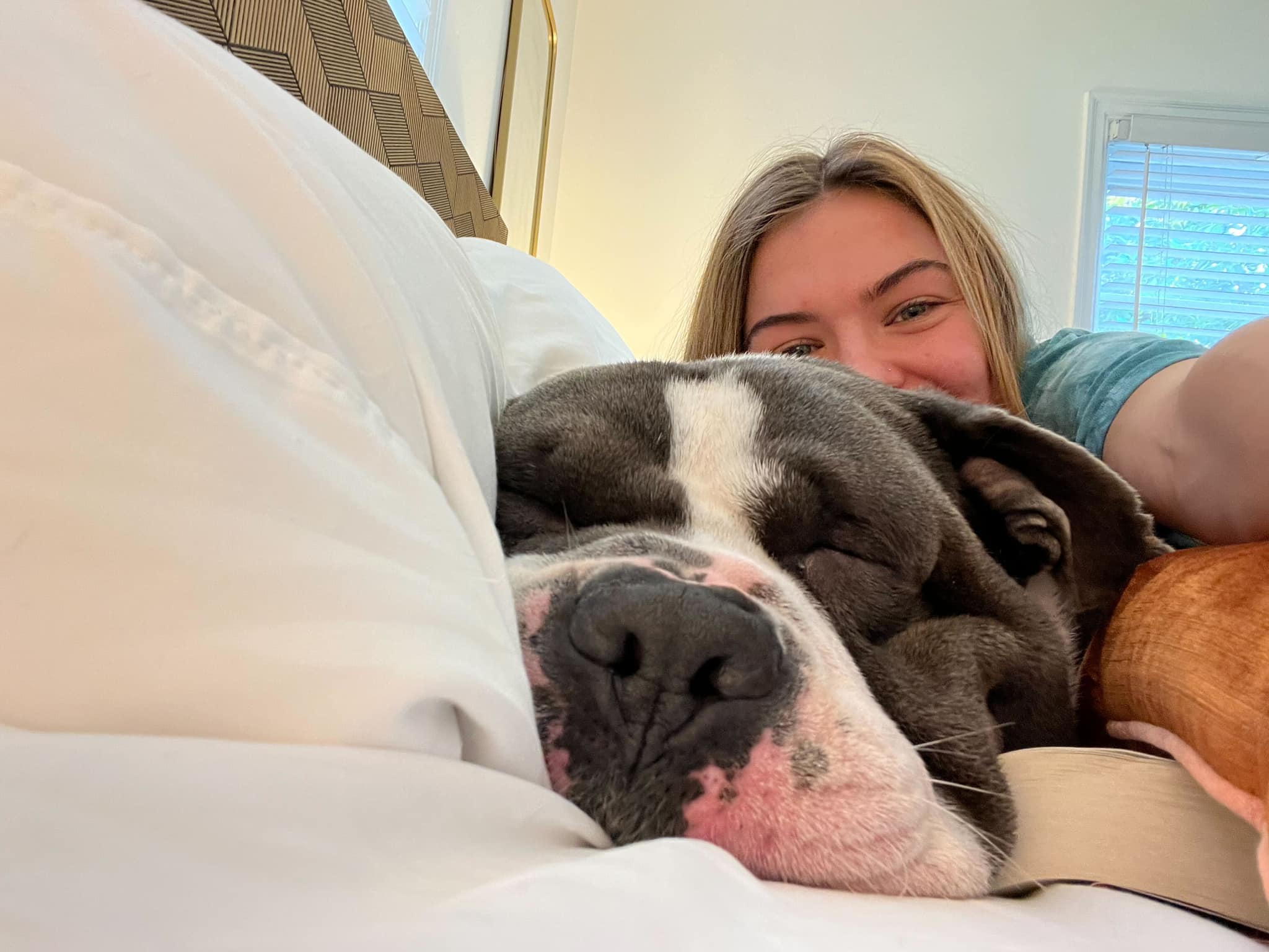woman and dog in bed