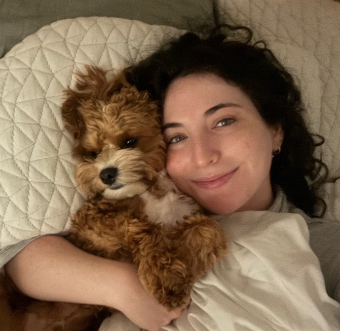 woman cuddling a dog 