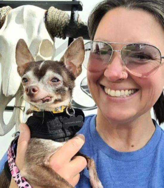 woman holding small dog 