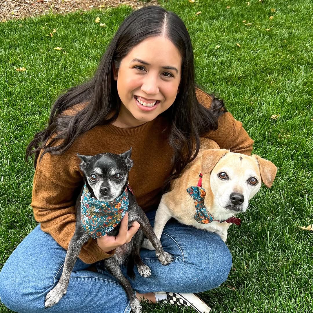 woman holding two dogs