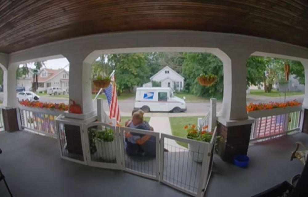 woman hugging a mailman