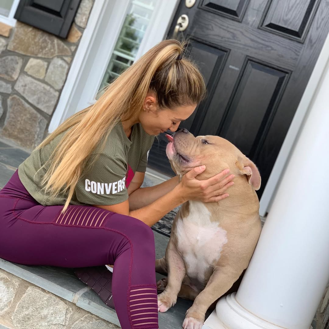 woman kissing a dog