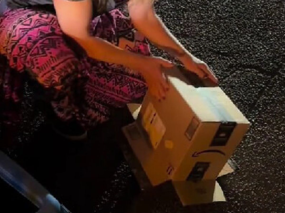woman lifting cardboard box 