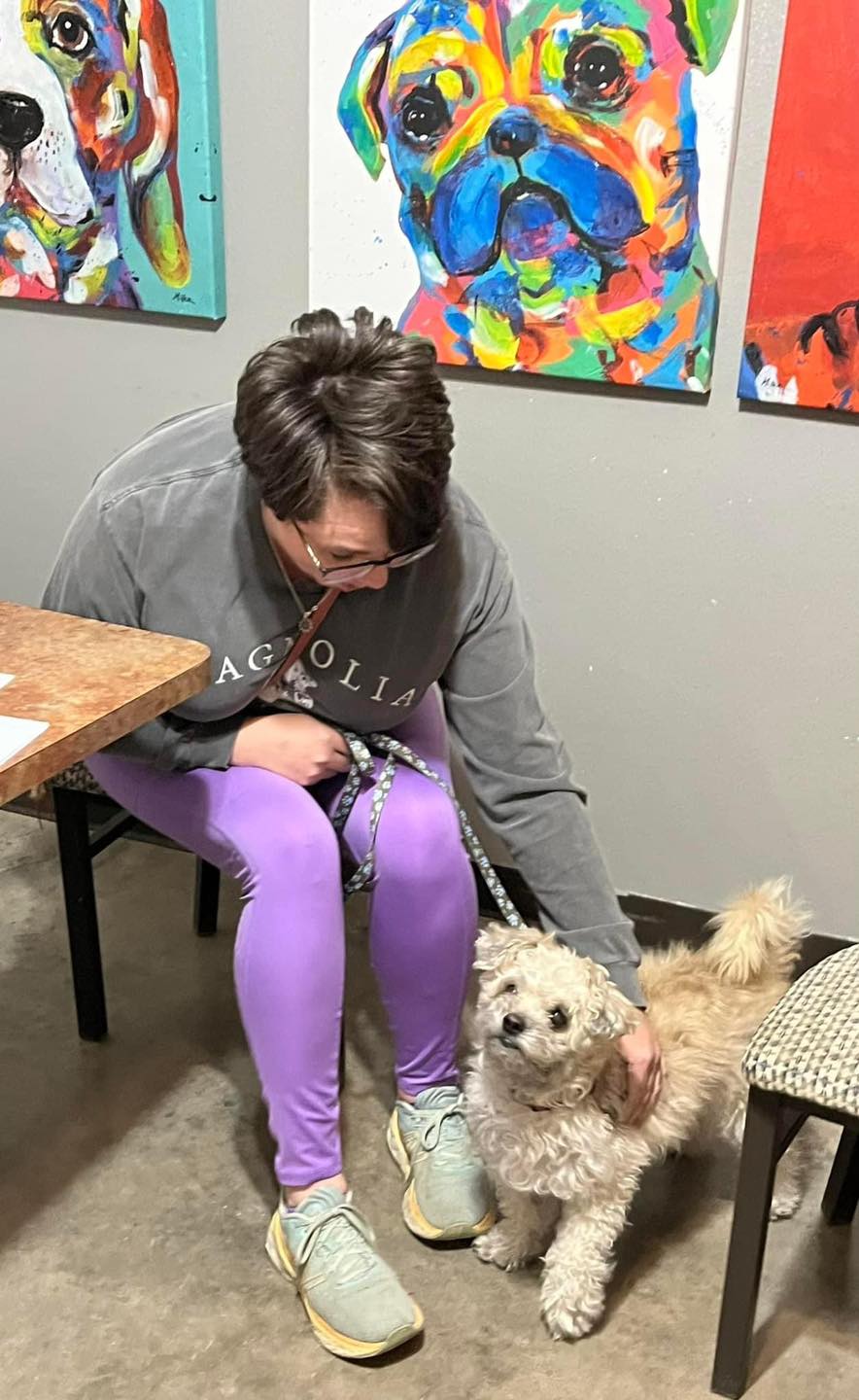 woman petting a fluffy dog