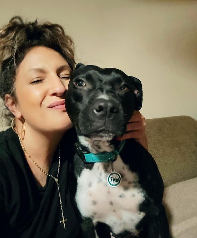 woman posing with pretty black and white dog
