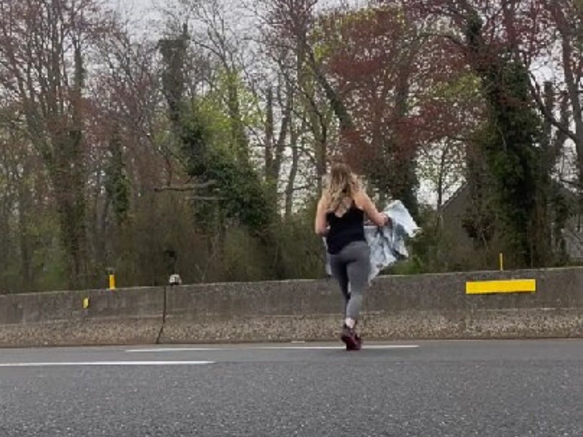 woman running across the highway 