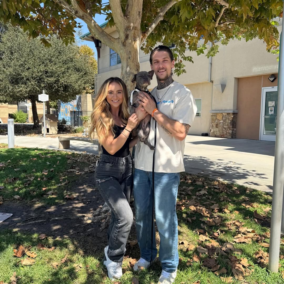 Couple holding a dog
