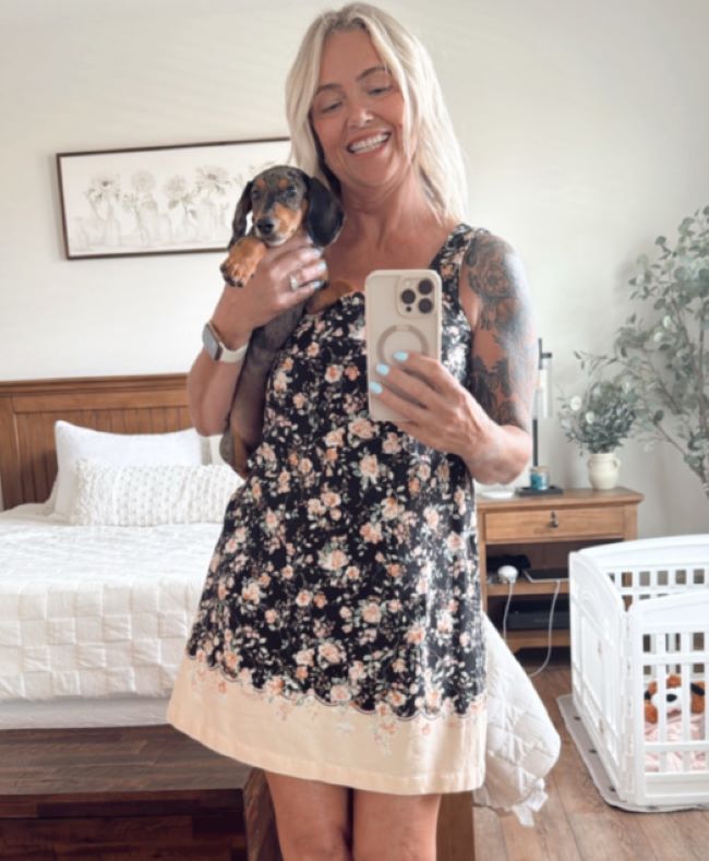 blonde woman holding a tiny dog