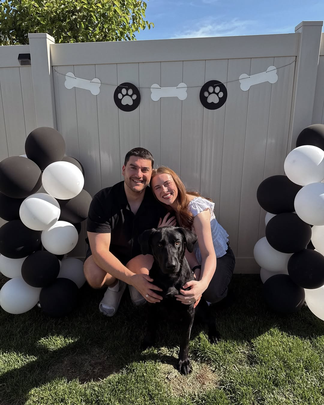 couple and adopted black dog