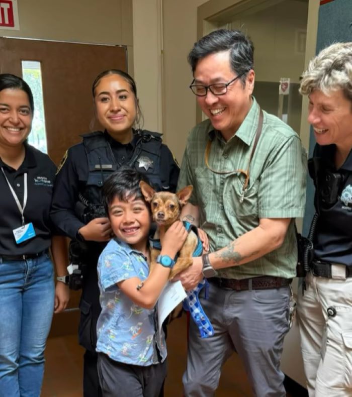 happy kid holding a dog