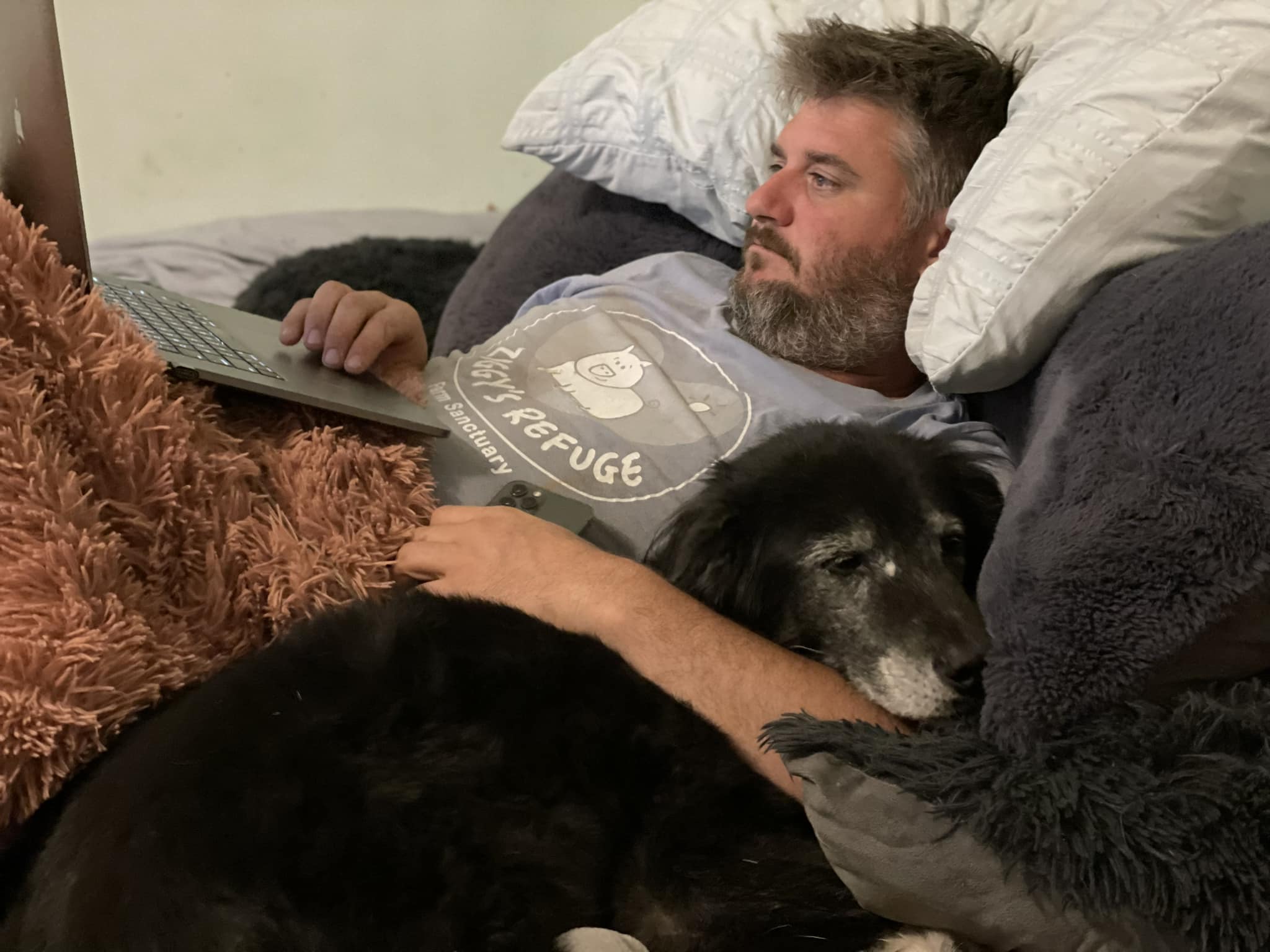 man and dog in bed