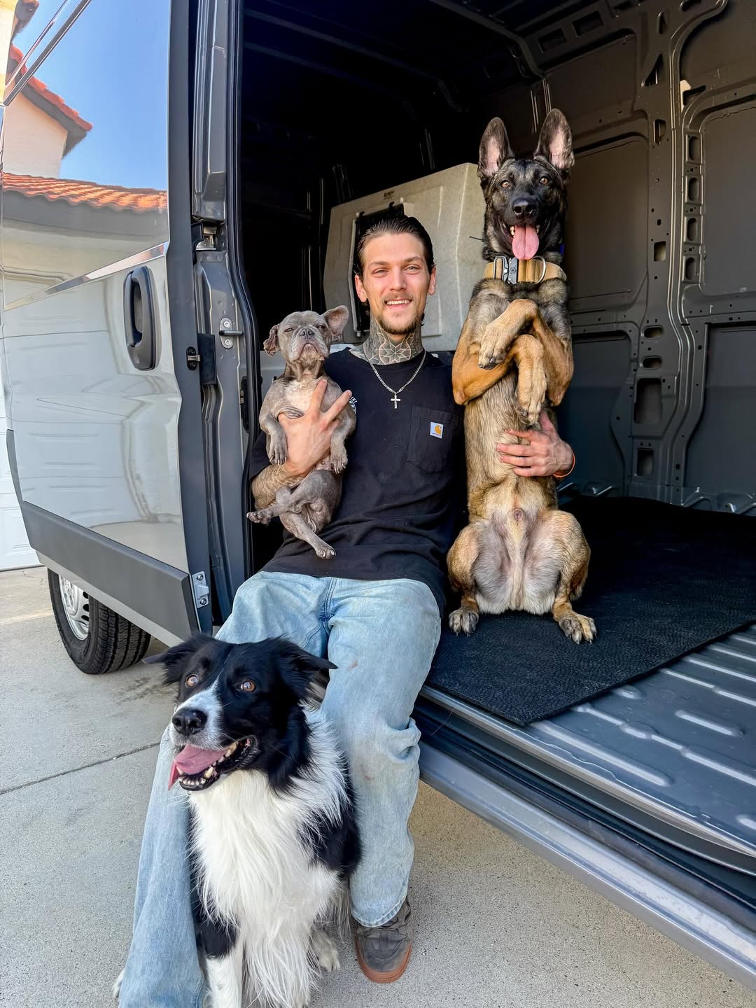 man and three dogs