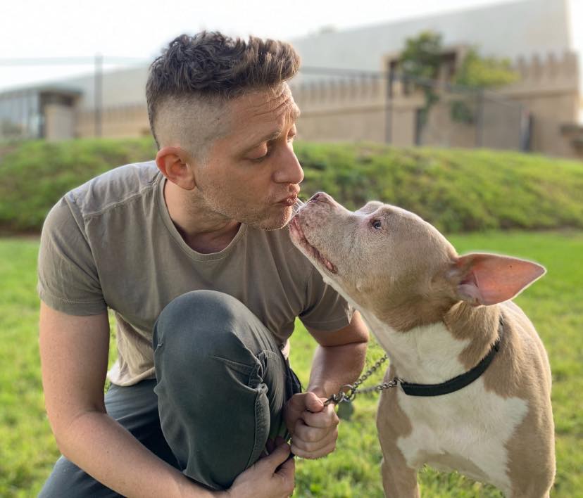 man kissing a dog