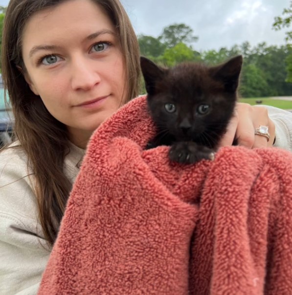 woman and black kitten