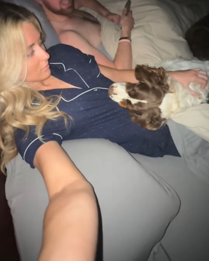 woman and dog in bed