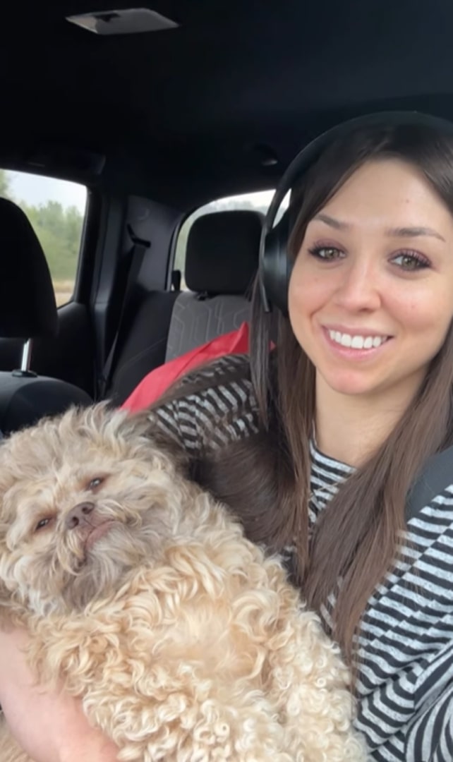 woman and dog in car