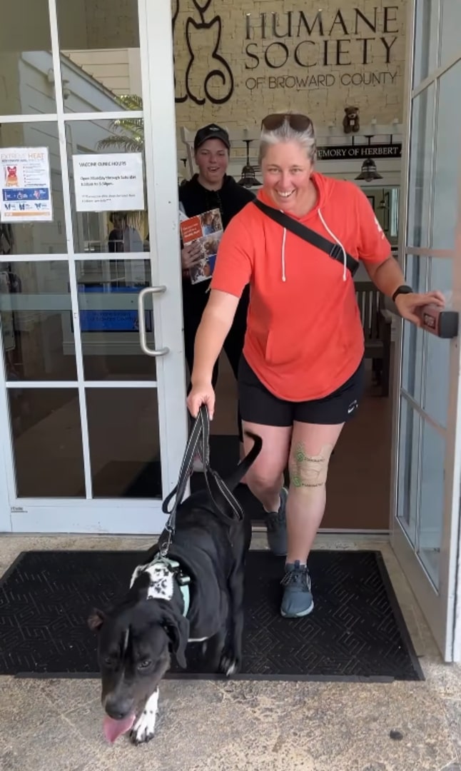 woman and dog walking out of the shelter