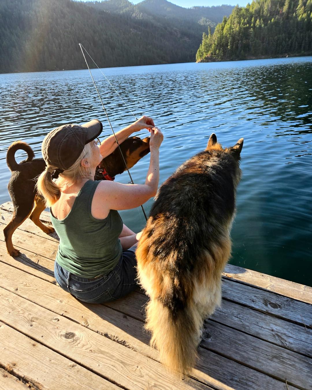 woman and two dogs fishing