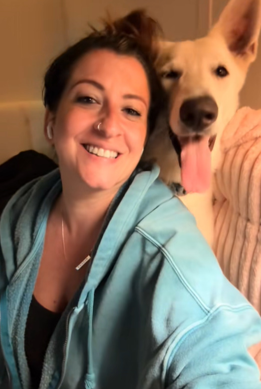 woman and white dog in house