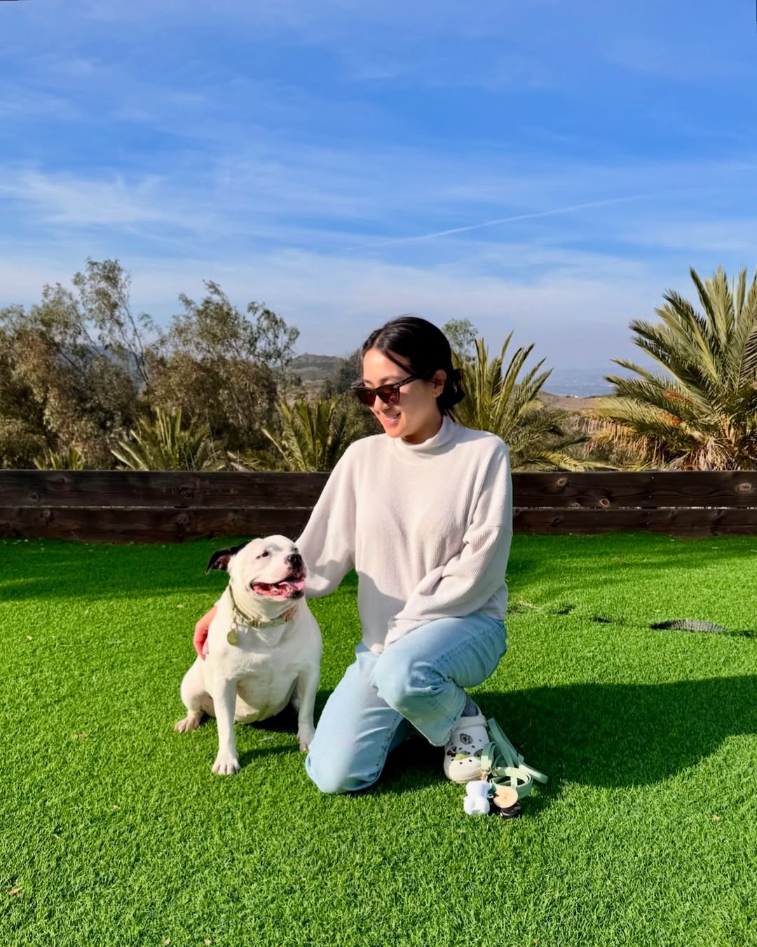 woman and white shy dog