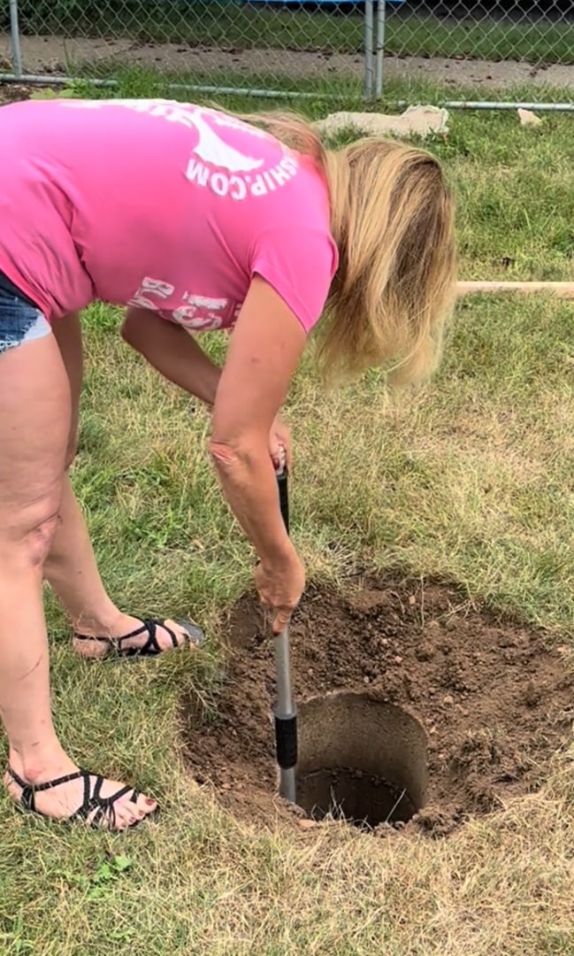 woman digging up a hole