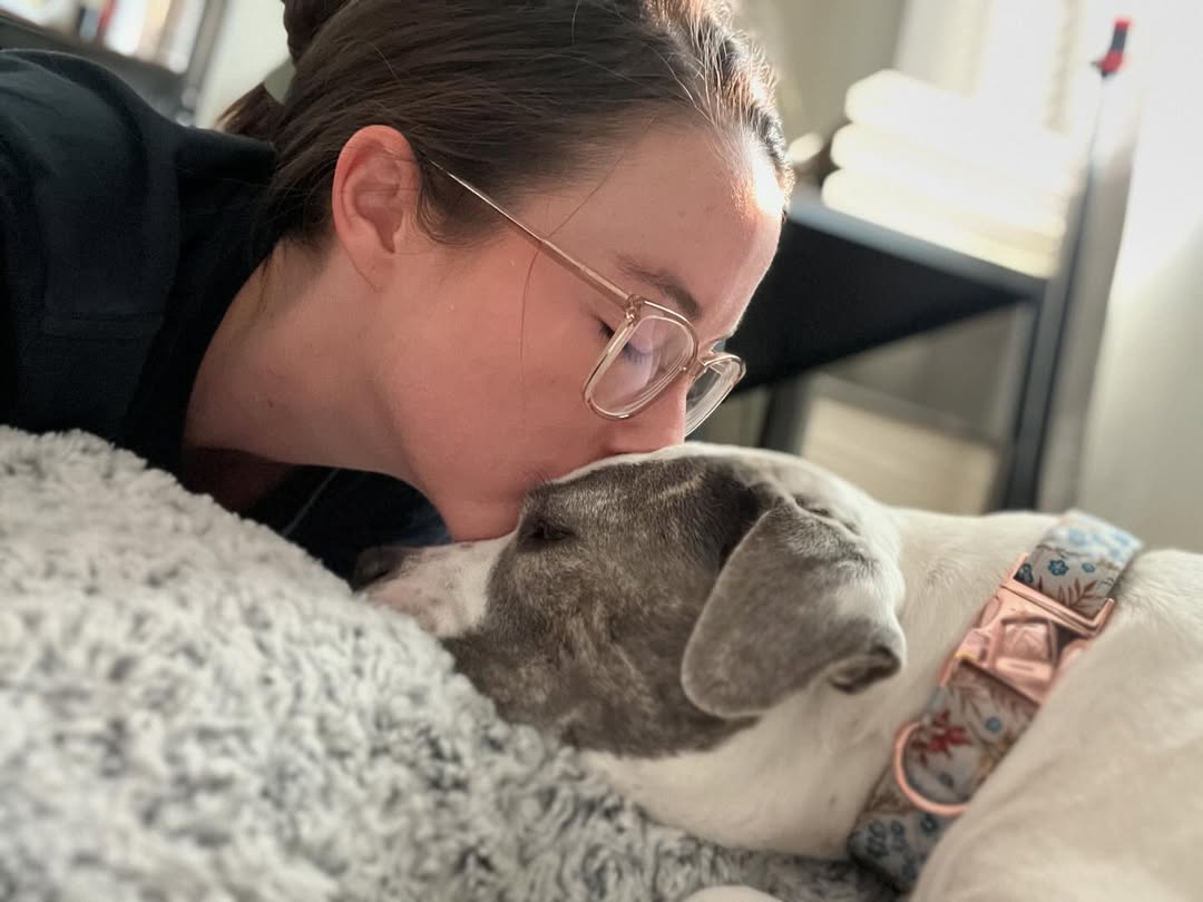 woman kissing a dog
