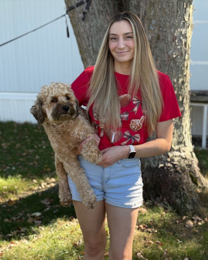 young woman holding a dog