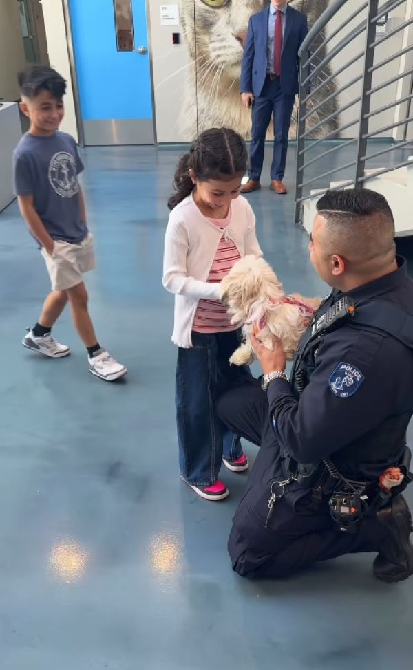 The girl approached the dog and the policeman