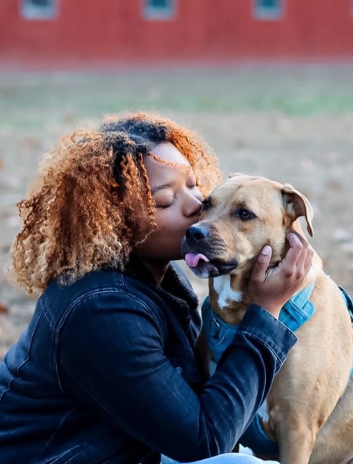 The girl kisses the dog