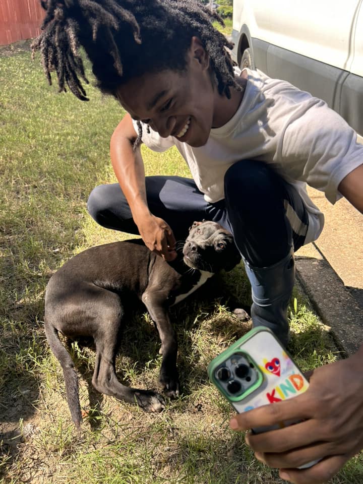 a boy takes a picture with a dog