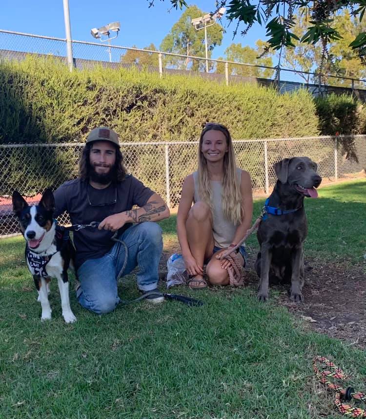 a man and a woman with two dogs