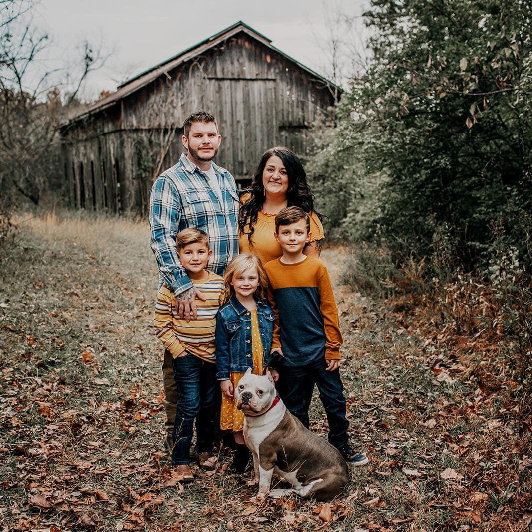 family in the forest with a dog