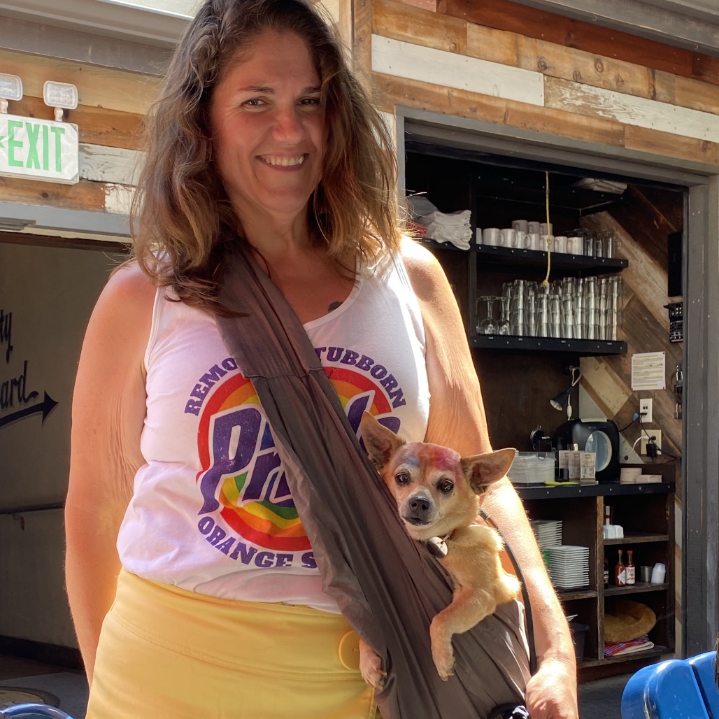 girl holding a dog in a carrier