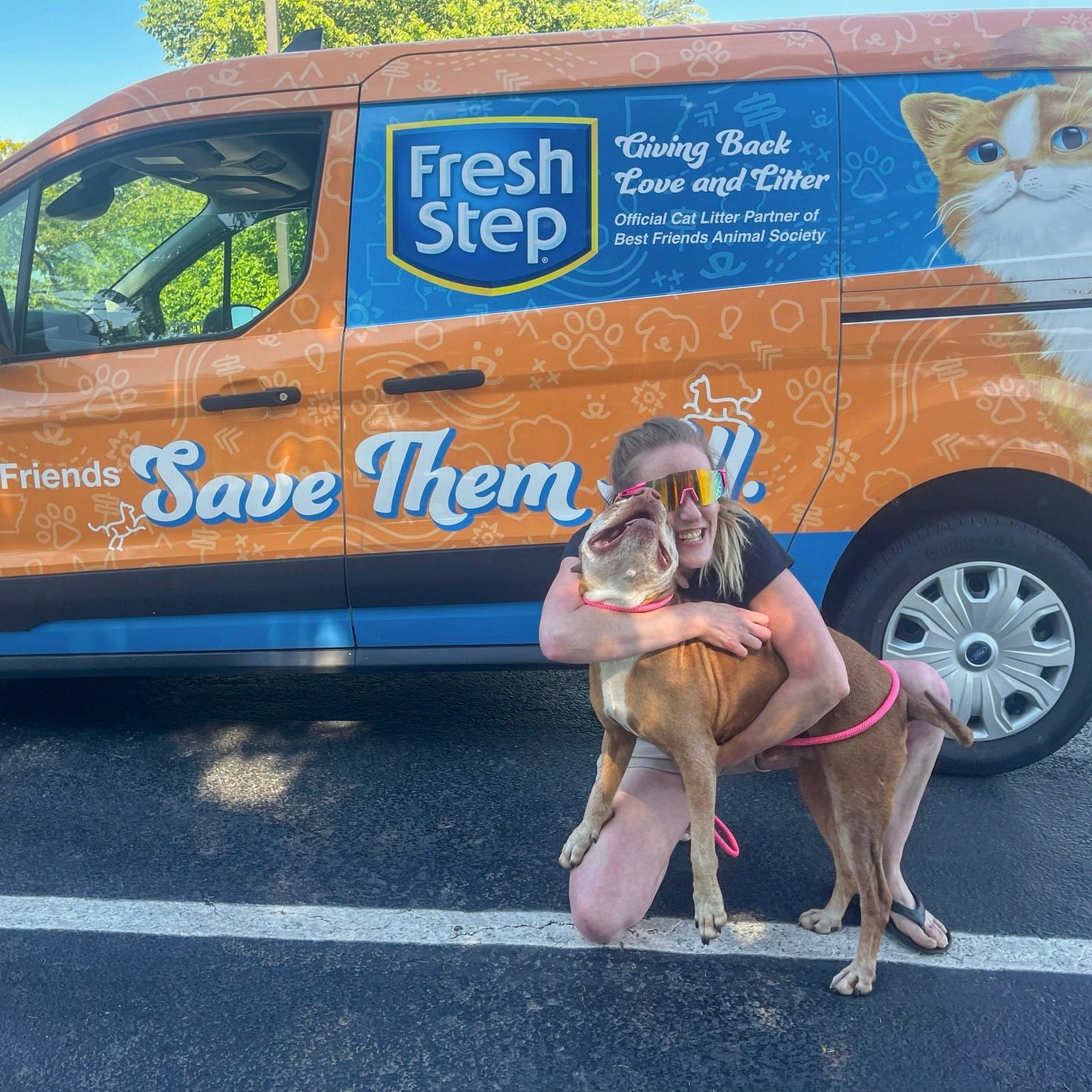 girl hugging a dog on the road