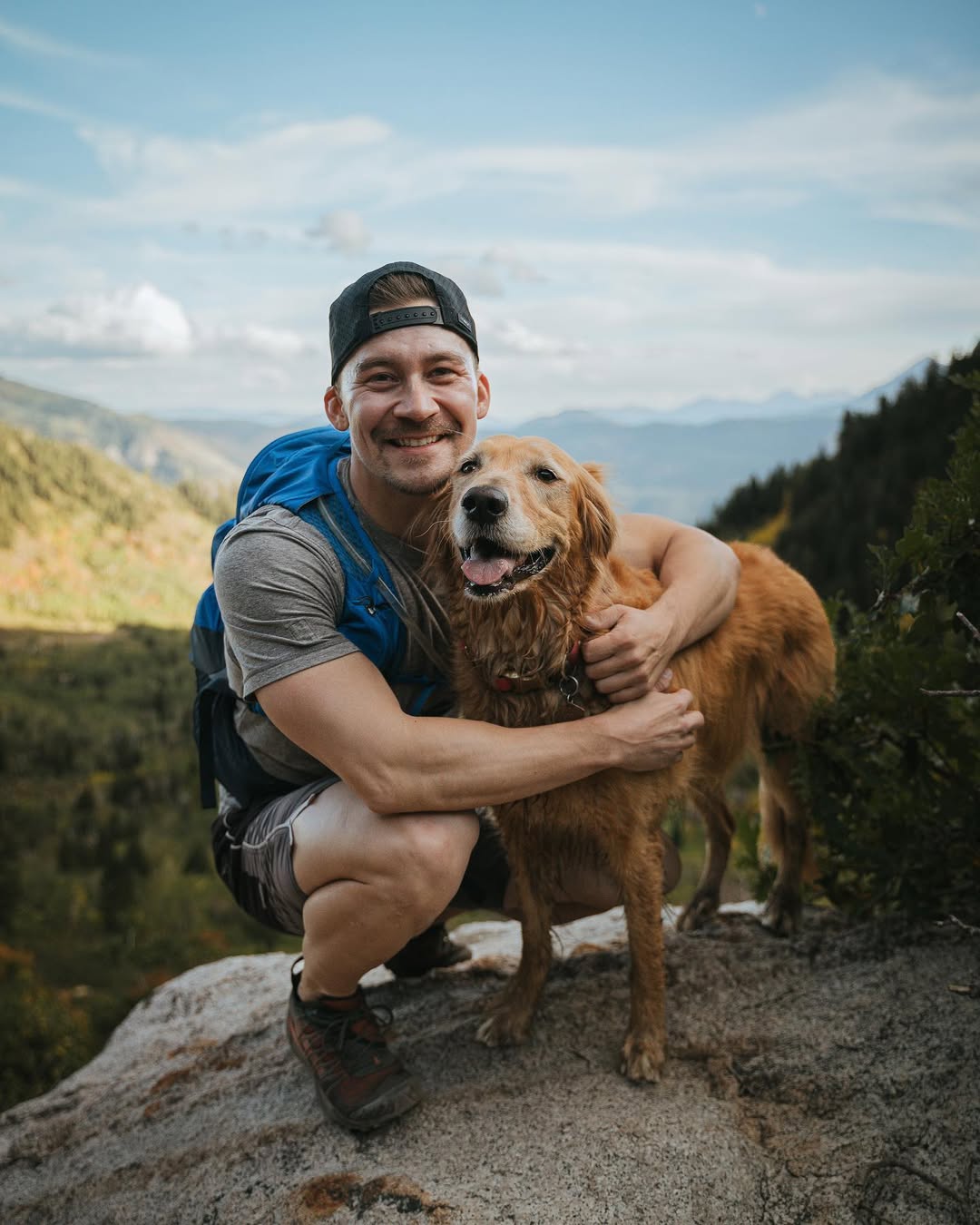 man hugging a Golden Retriever