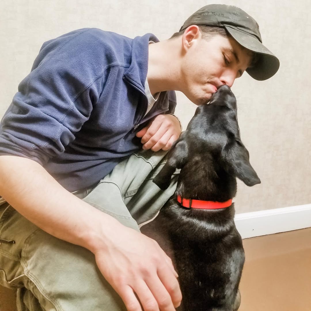 man kissing a deaf dog