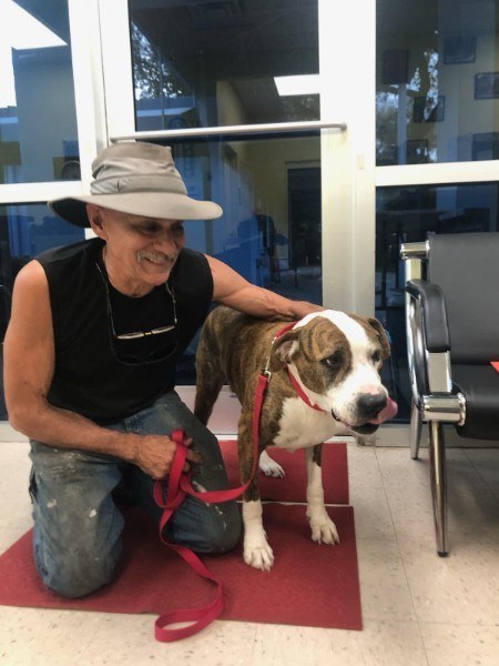 man with a hat on his head with a dog