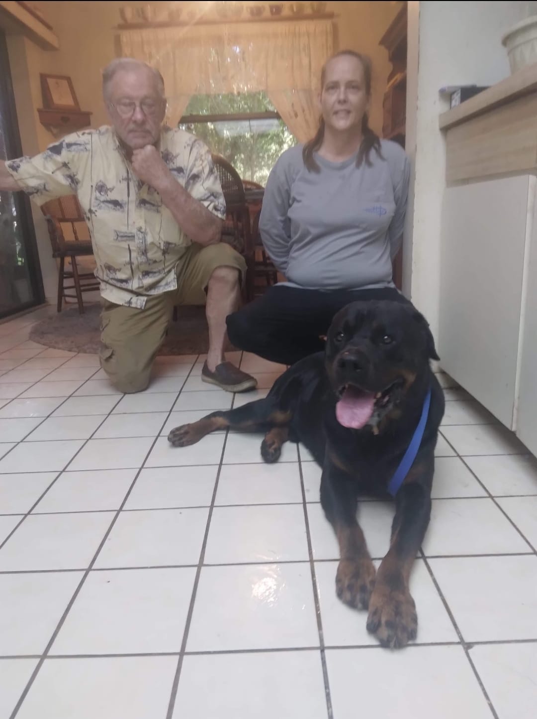 old couple and black Rottweiler