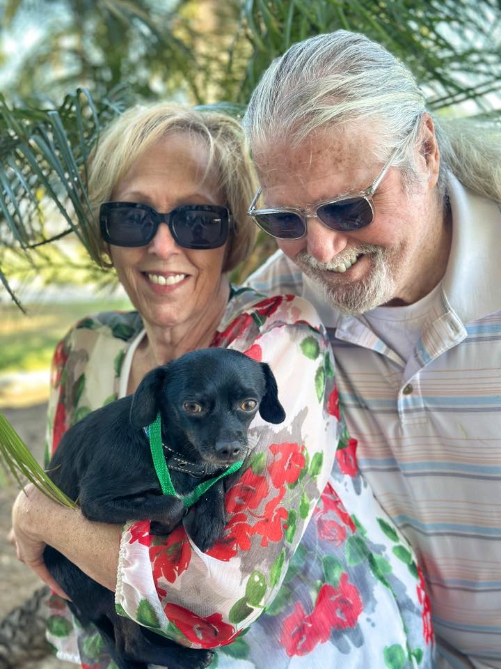 old couple and black dog