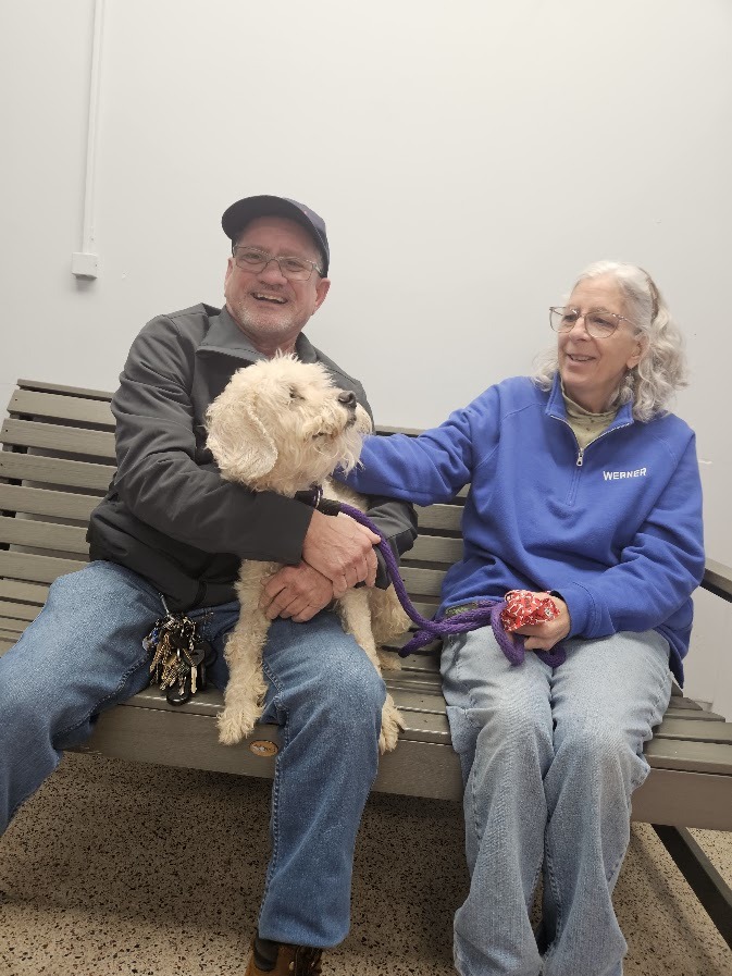 old couple and white dog