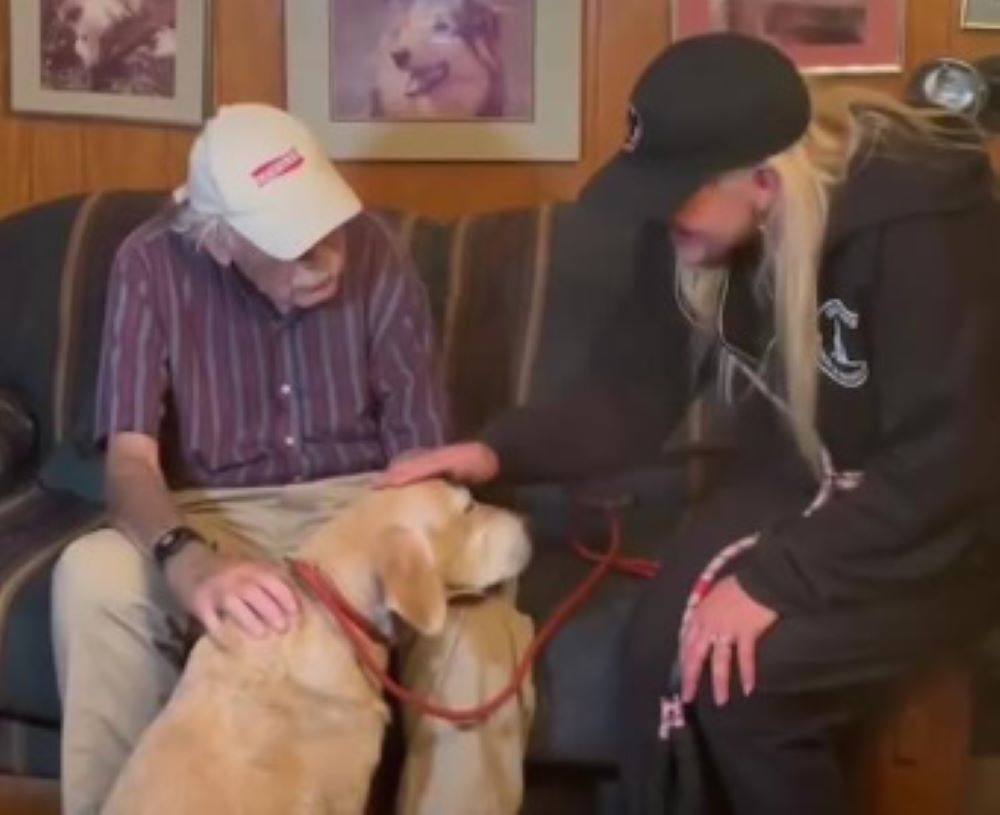 old man and young man with dog