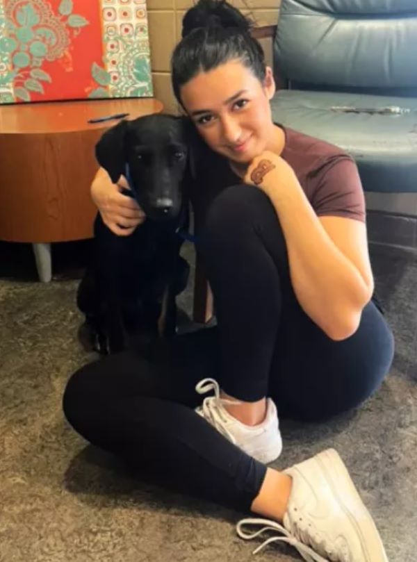woman and adopted black dog