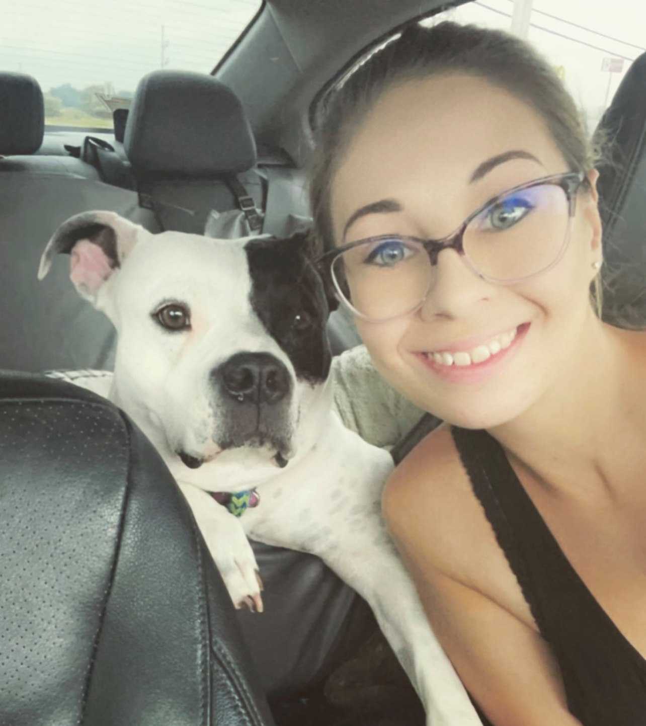 woman and dog in car