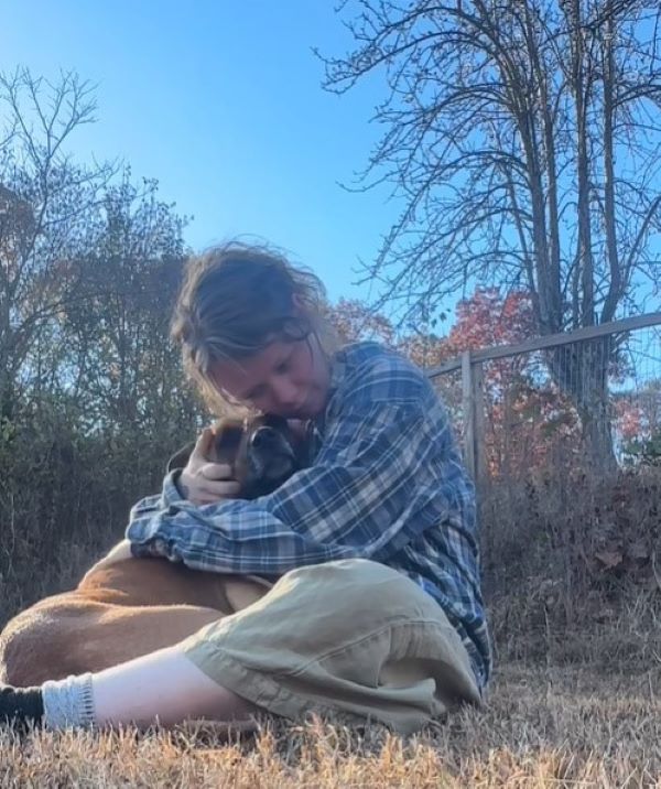 woman huggin a dog