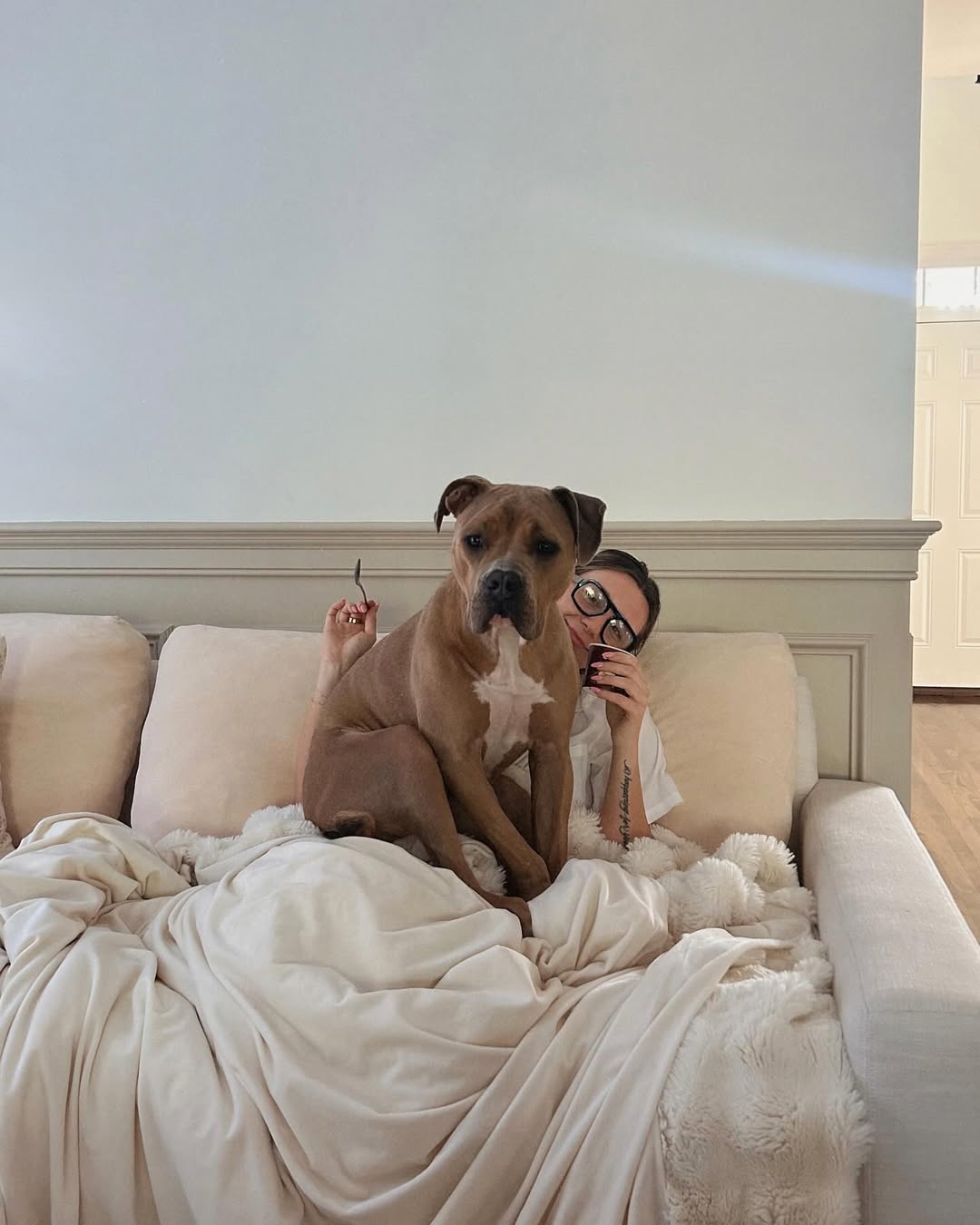 woman with dog in bed