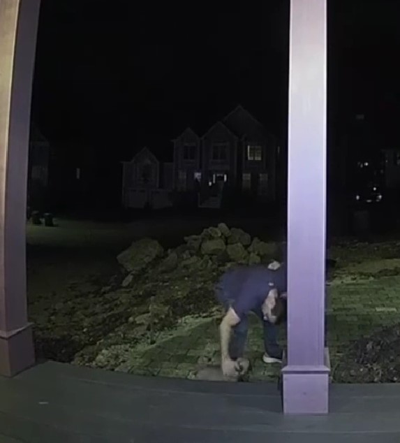 A man is petting a dog outside