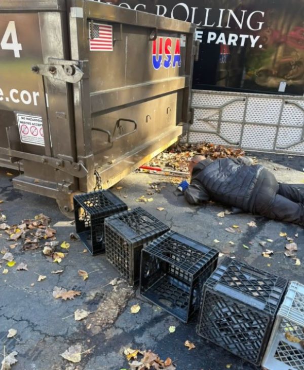 A man looks under a container