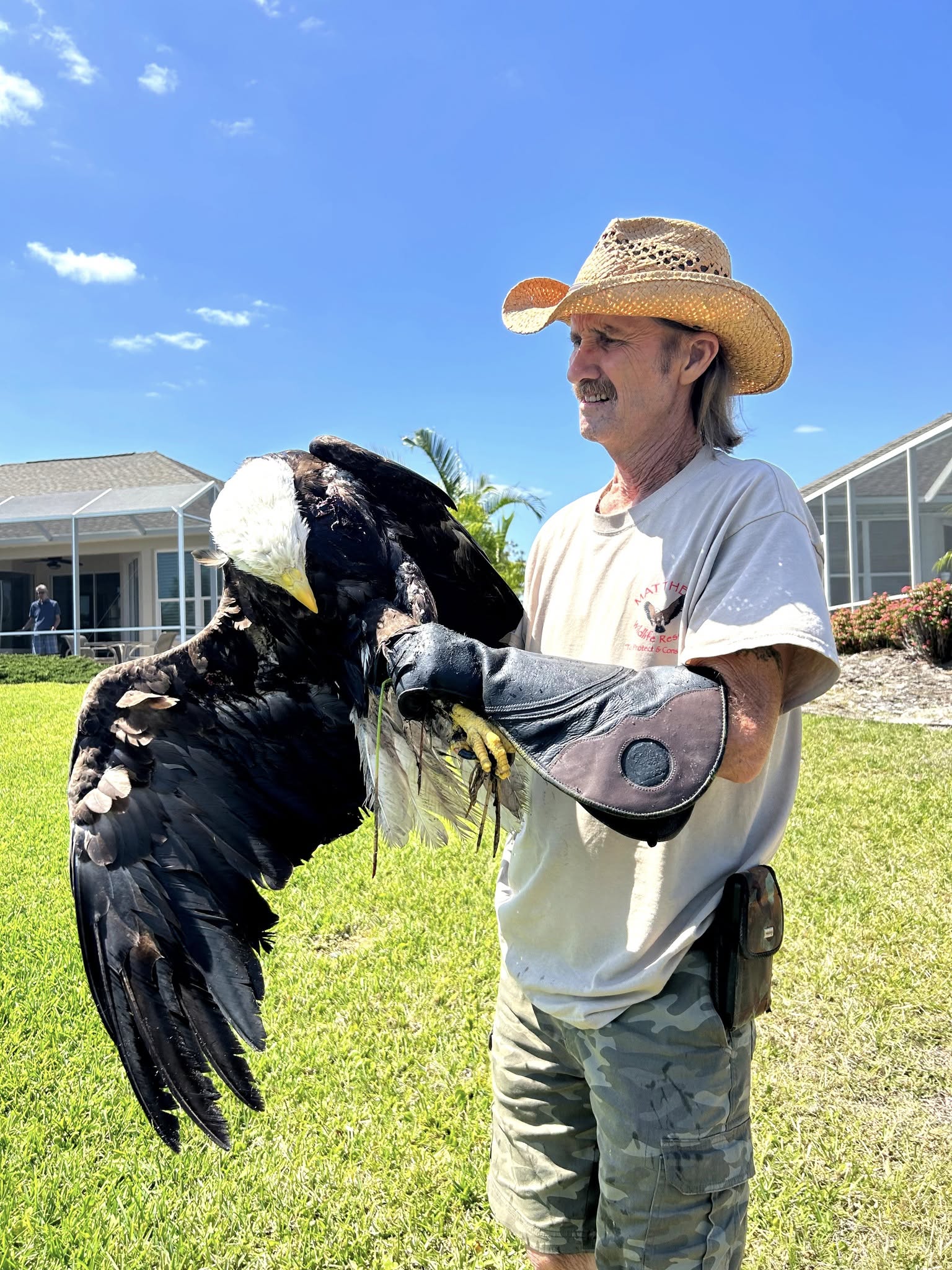 a man holding an eagle in his hand