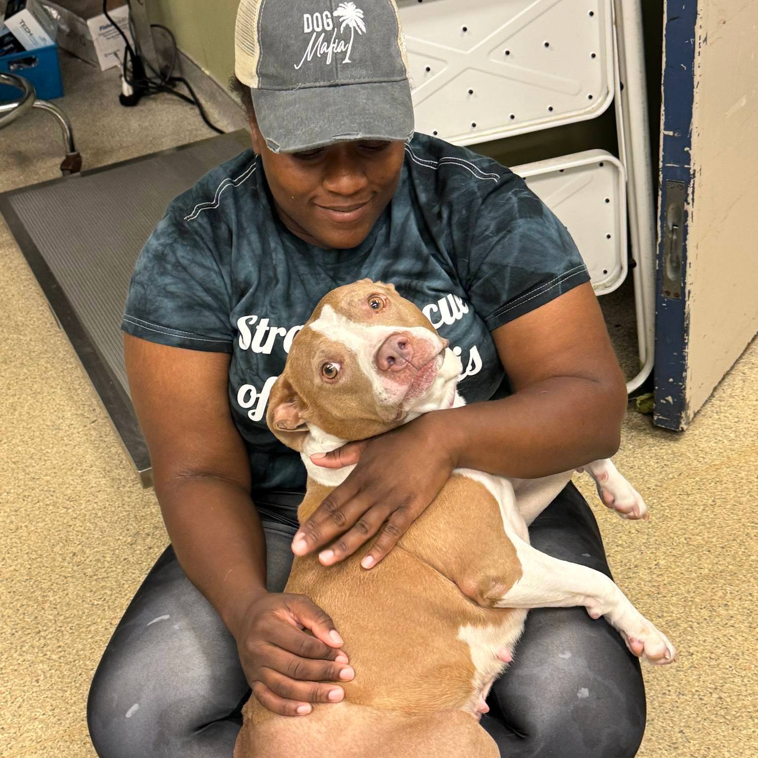 a man holds a dog in his arms